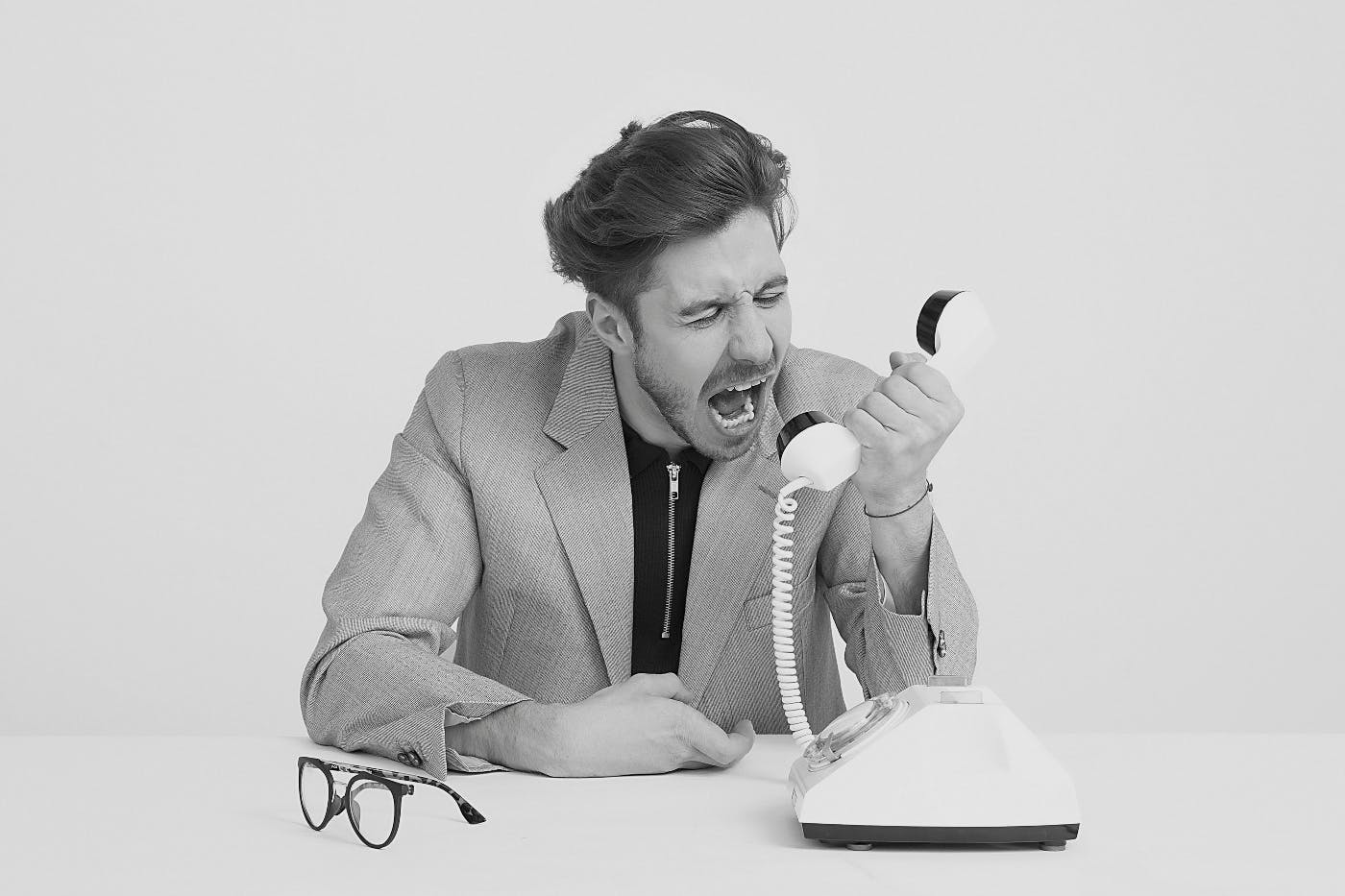 A man screaming into a telephone.