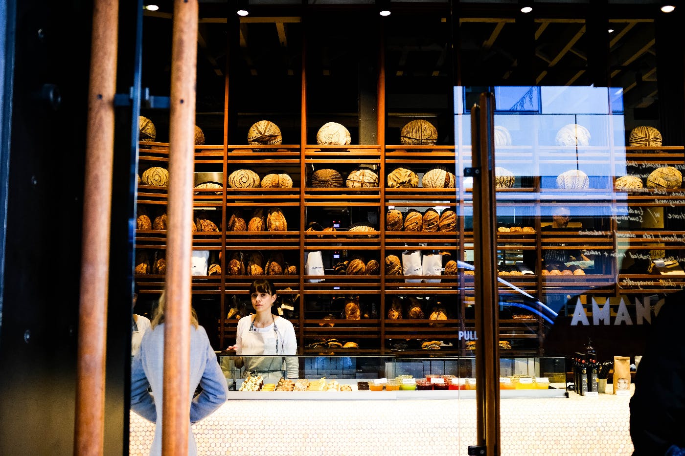 A view into a bakery with bread on shelves