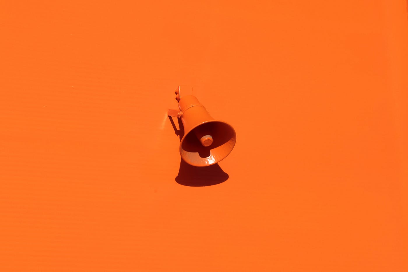 an orange bullhorn and an orange background