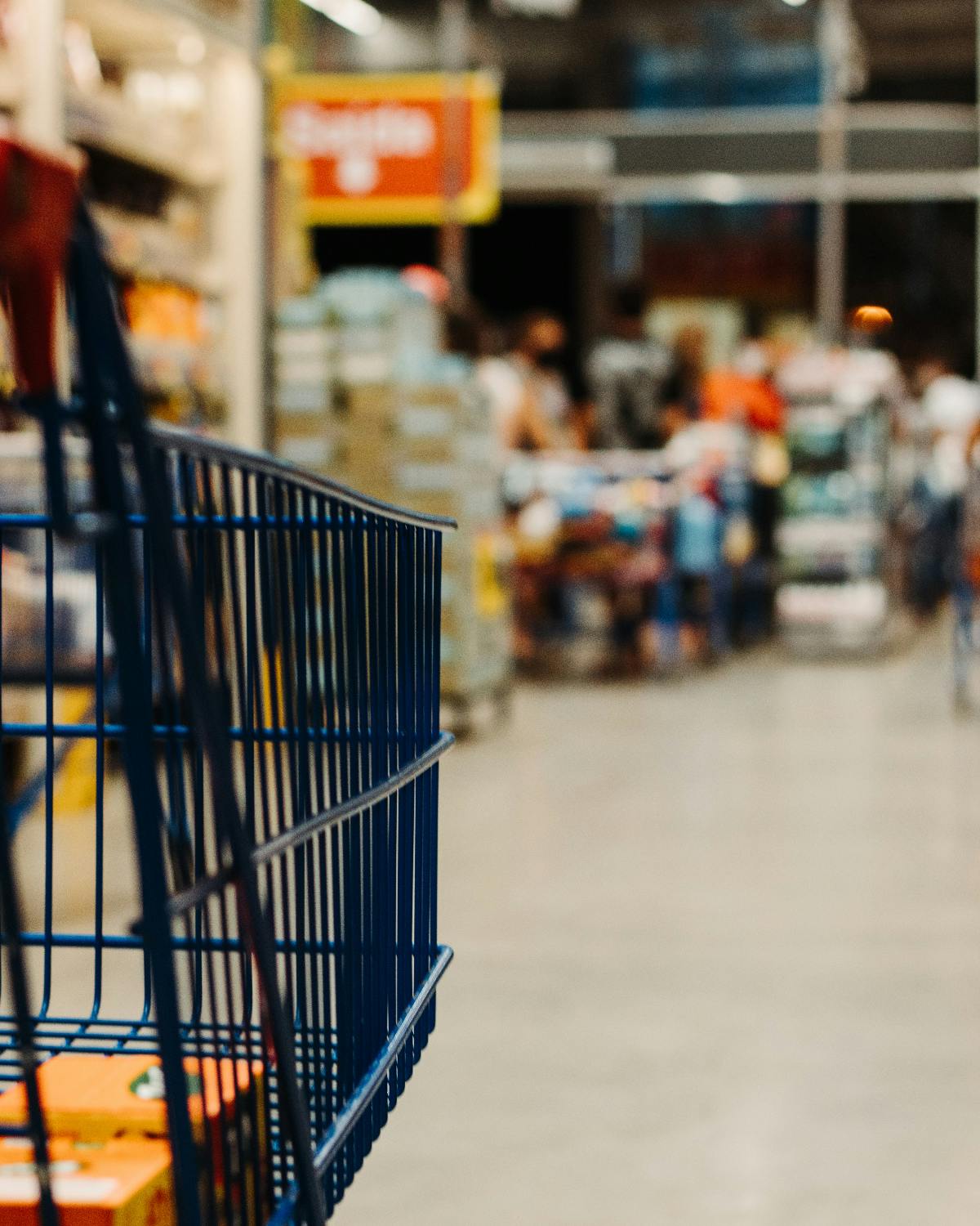 side view of a shopping cart in a store heading toward check out.