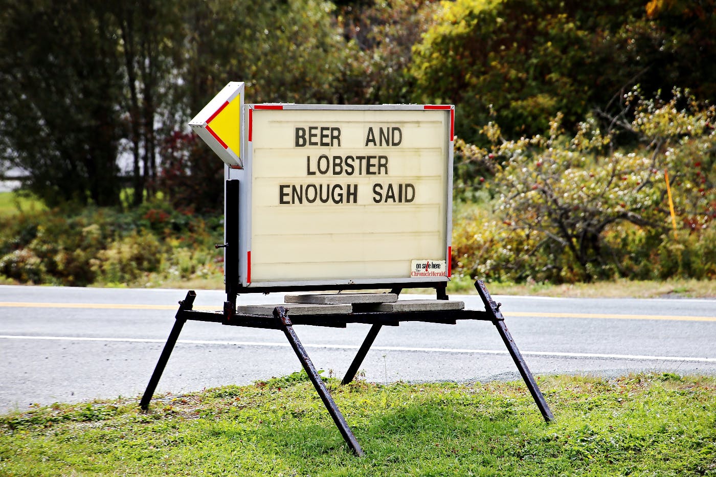 A street sign reading BEER and LOBSTER ENOUGH SAID