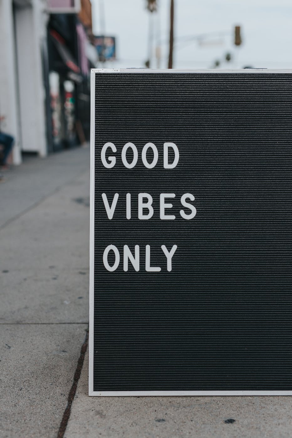 A sign on a street reading Good Vibes Only