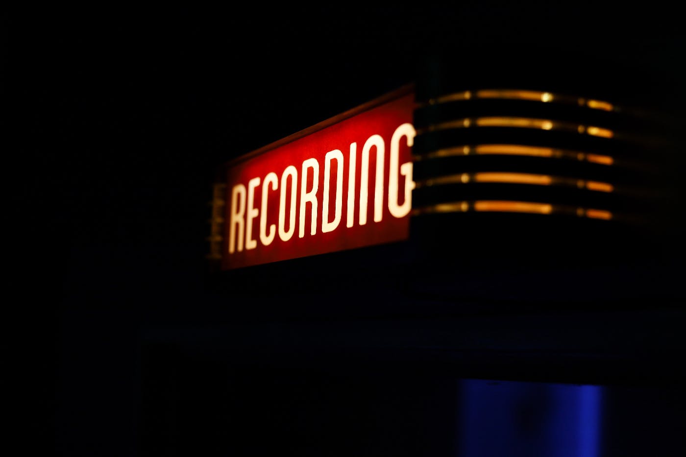 A recording studio with the recording sign lit