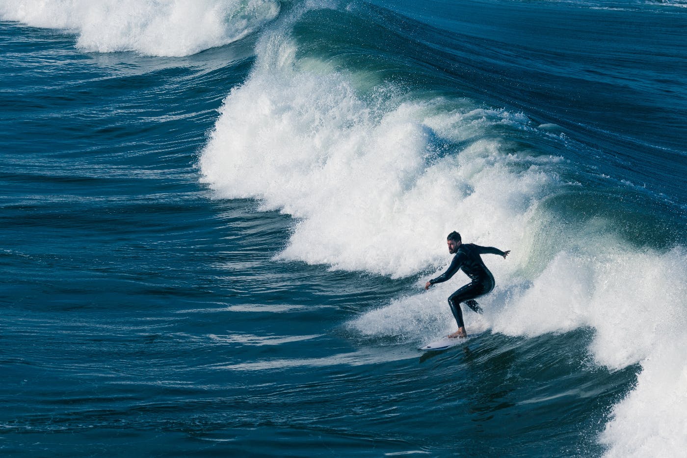 a guy in a wet suit surfing