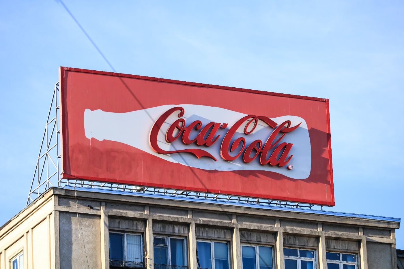 a Coca-Cola billboard atop a building