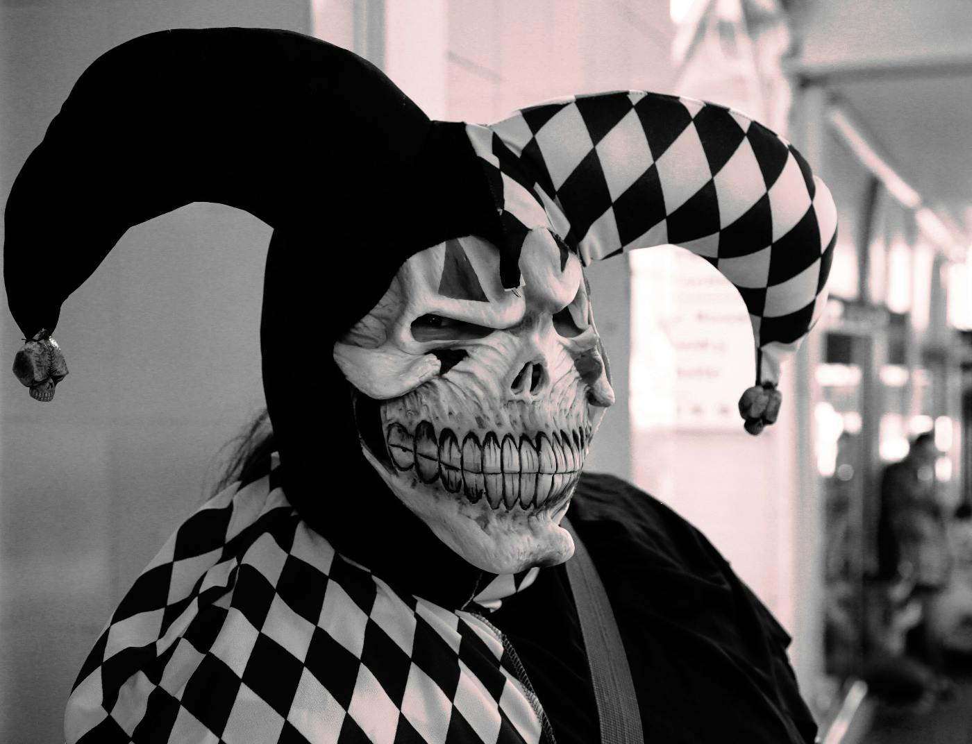 A skull in a black and white jester costume