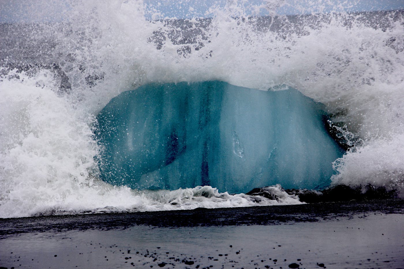A huge wave crashing on the shore