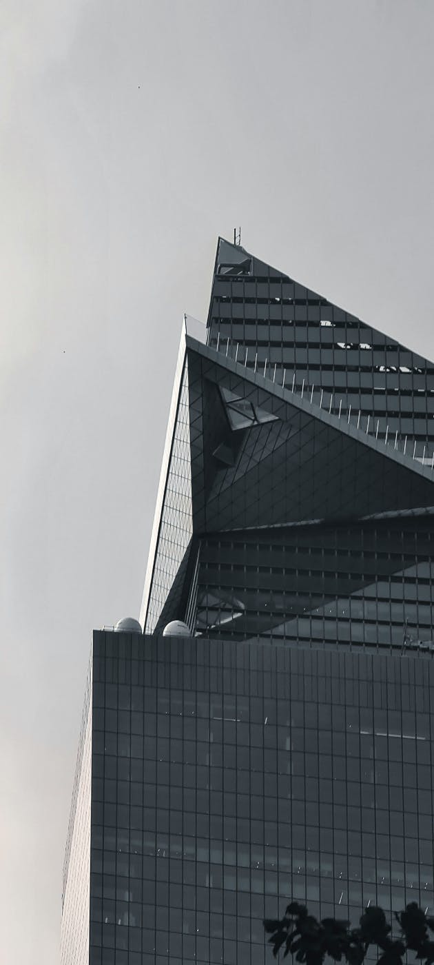 Black and White image of a tall building with triangular balconies