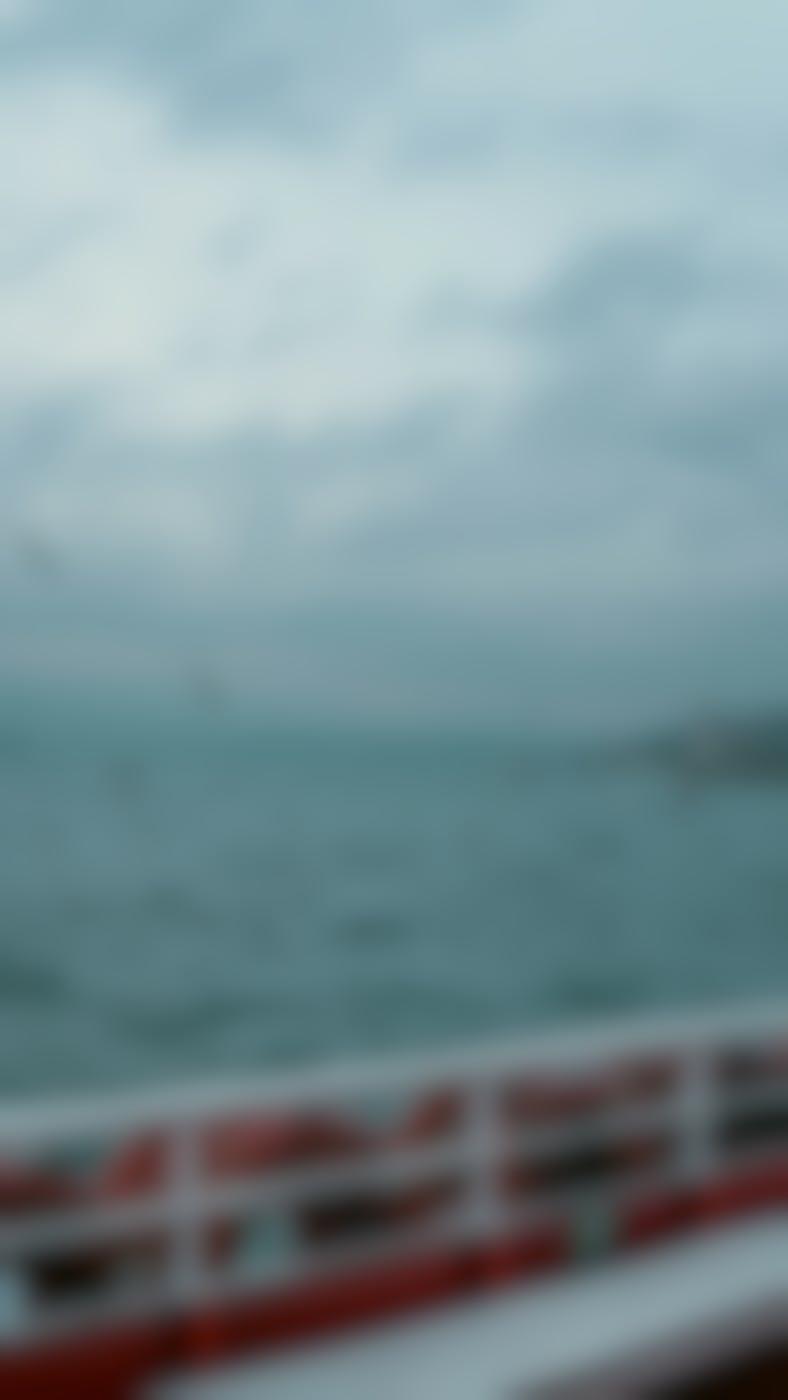 The view of a bay from the side of a boat life preservers in the foreground 