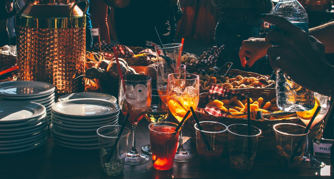 A table covered with food, drinks and other party items