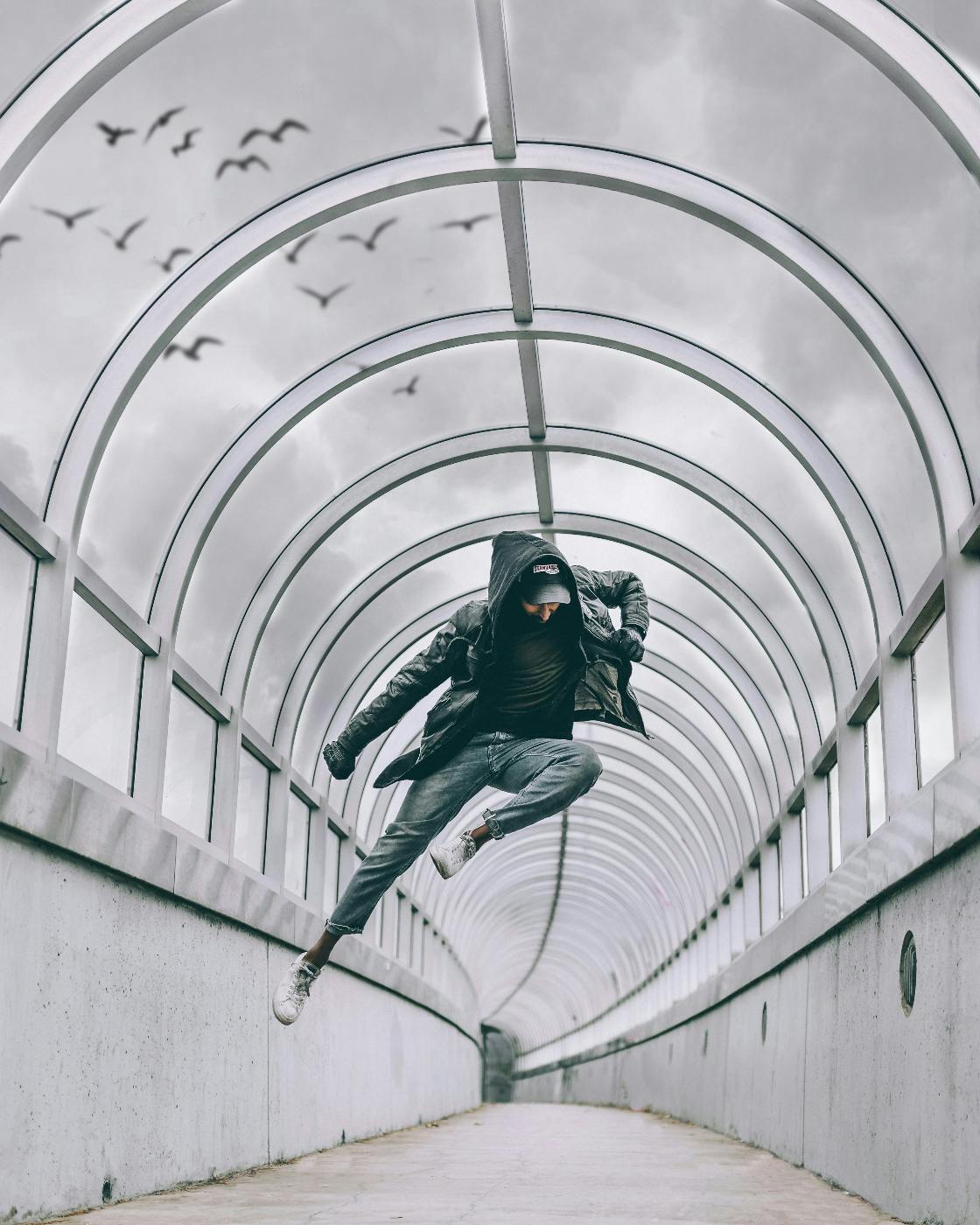 A man dancing inside a covered walkway