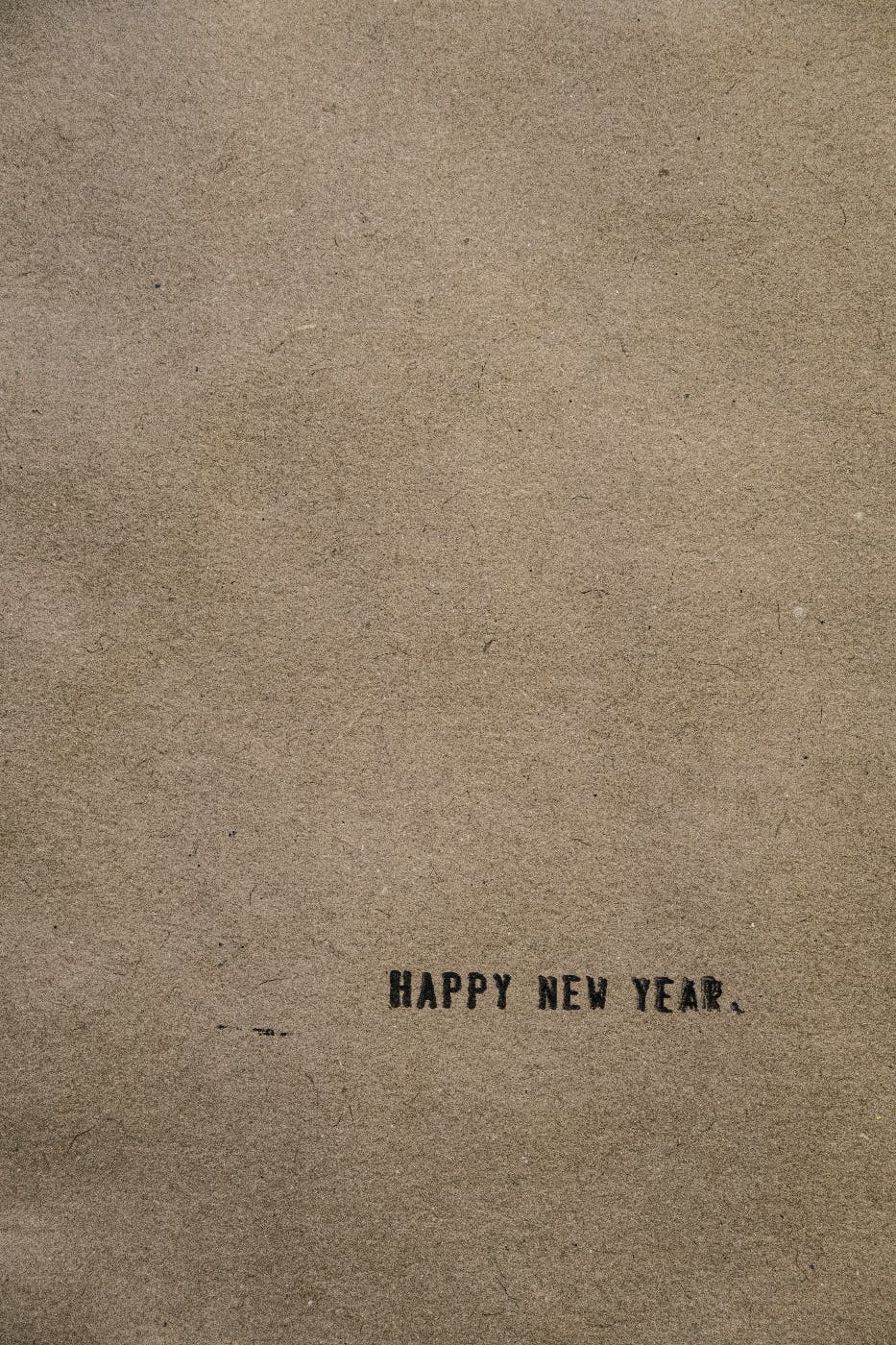 A brown page with Happy New Year typed in the bottom right corner