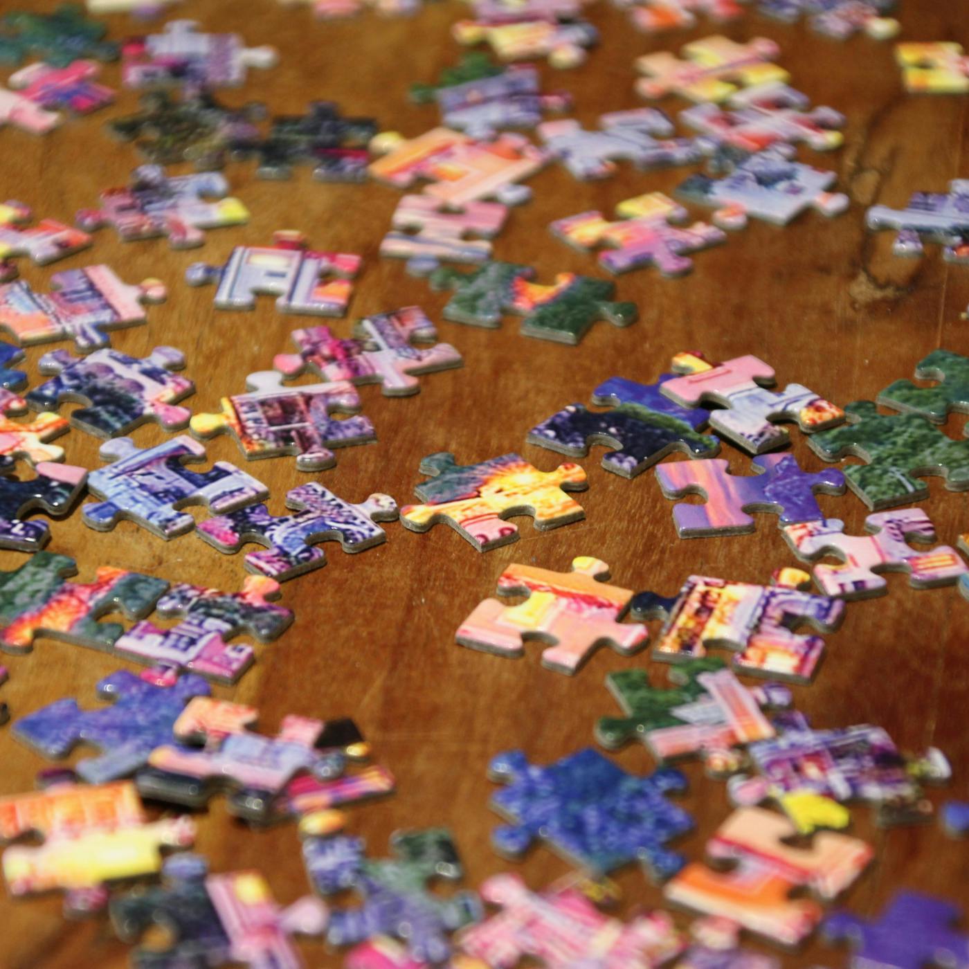 Pieces of a puzzle on a wood table