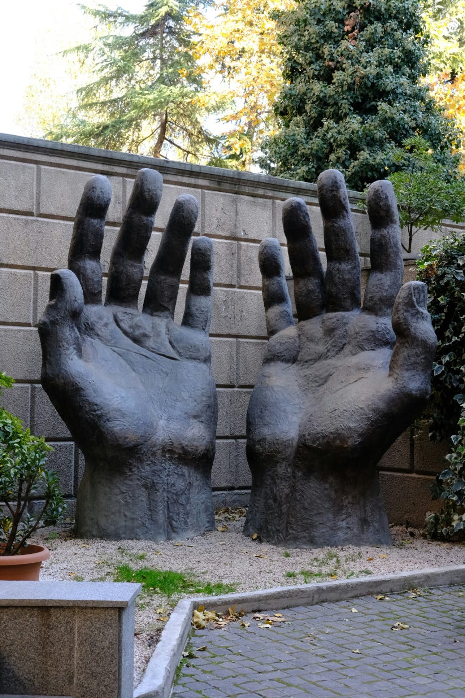 A statue of two giant hands reaching up