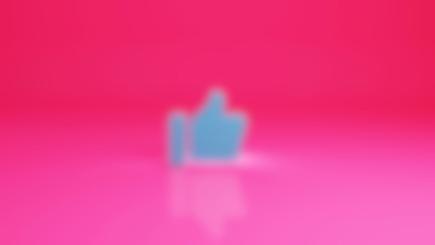 The blue thumbs up icon in front of a pink background