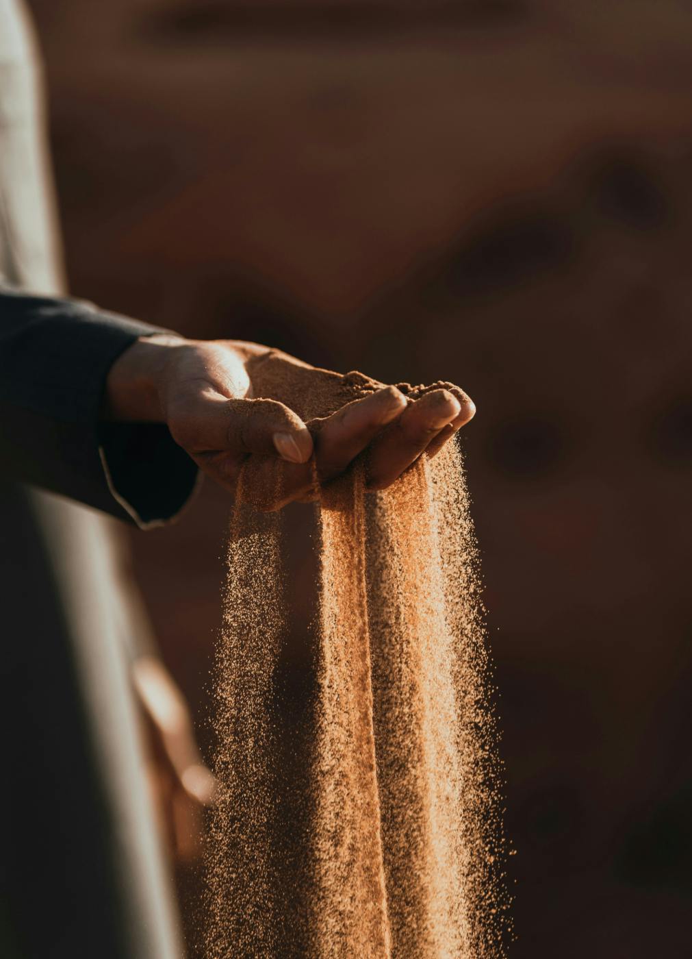 Sand pouring through and open hand