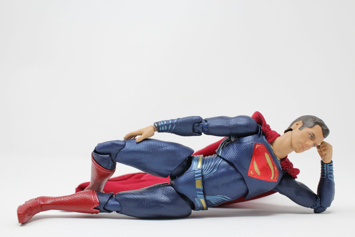 A reclining Superman action figure