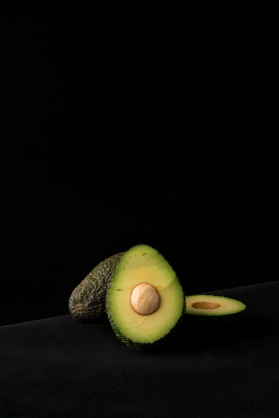 An avocado sliced to expose the pit