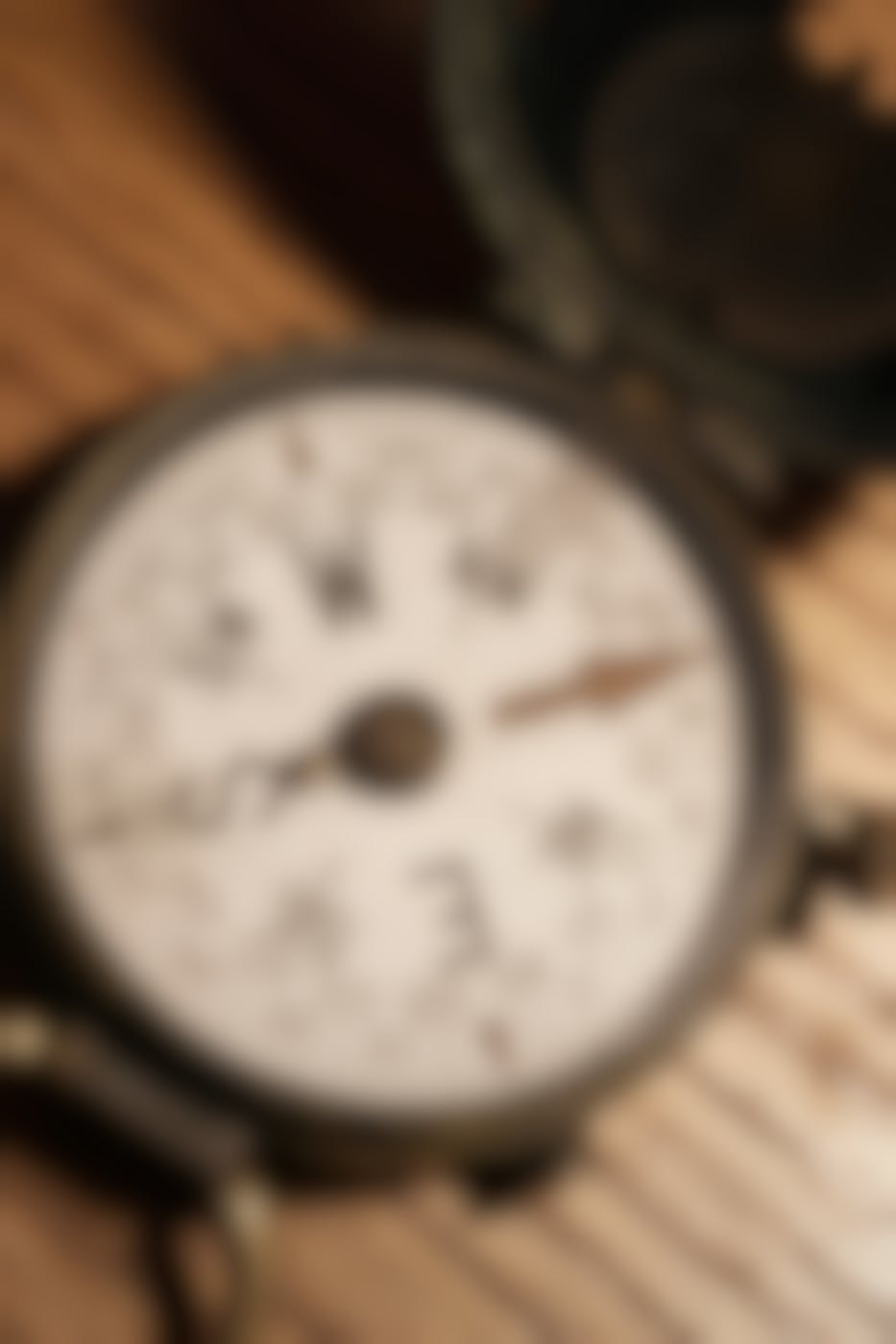 an old brass compass on a wood table