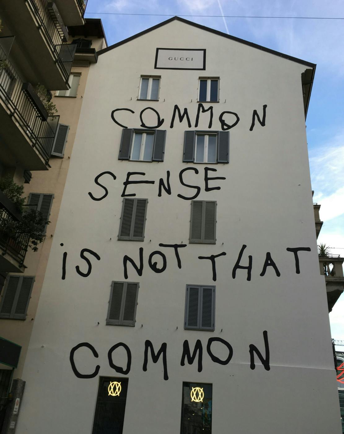 A house of Gucci building with Common Sense is not that Common written on the side