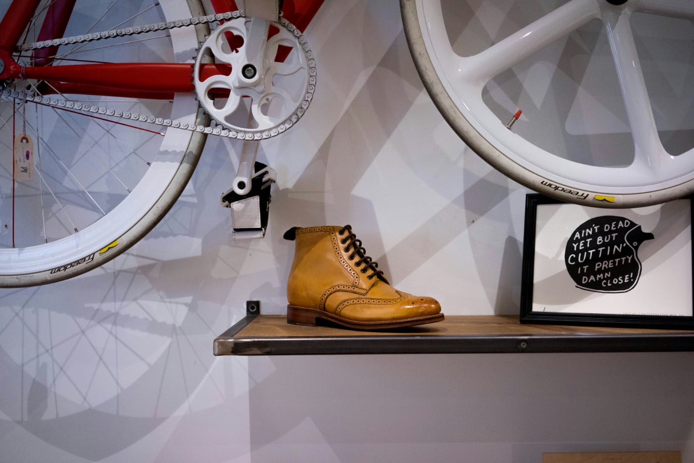 An unpaired shoe under a bicycle floating above it