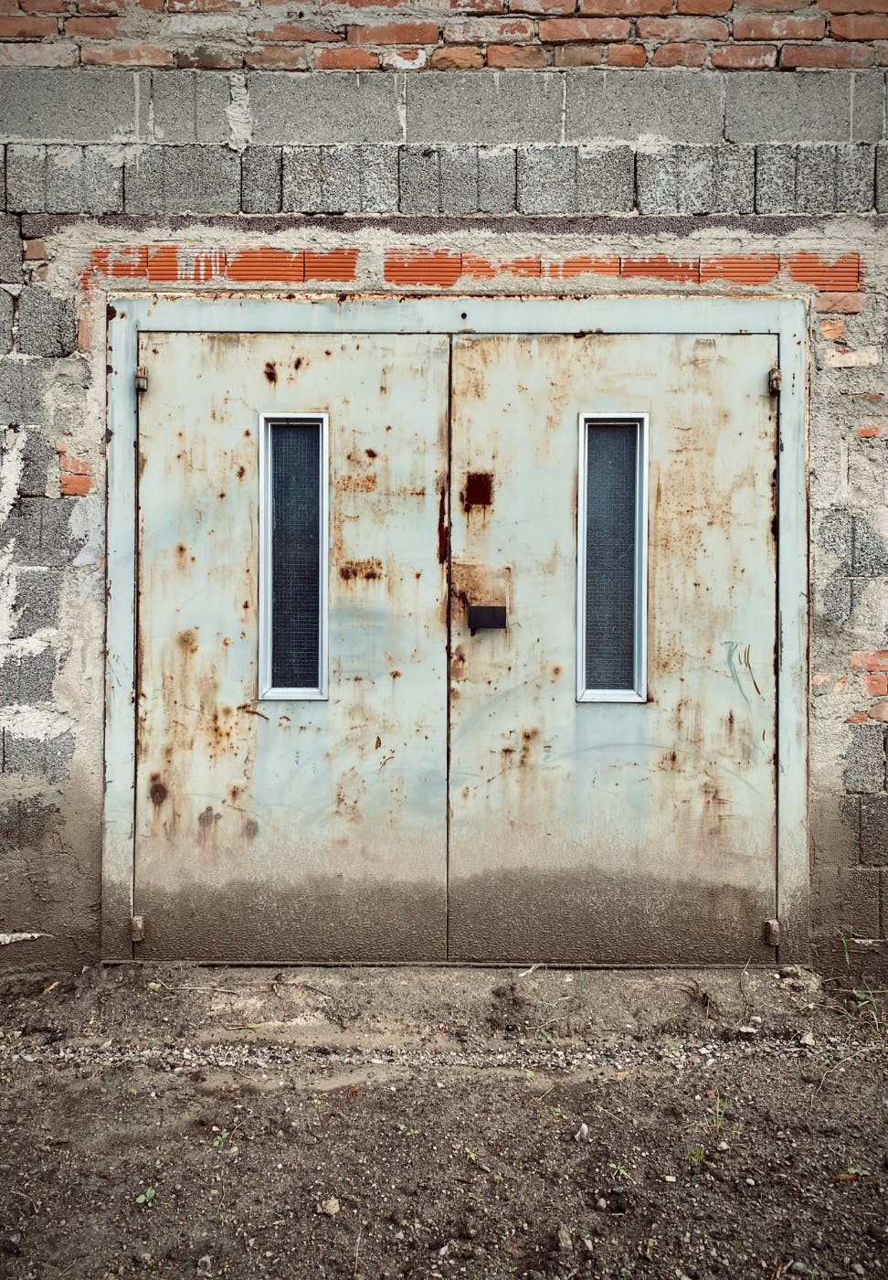 Rusted steel doors in a concrete wall