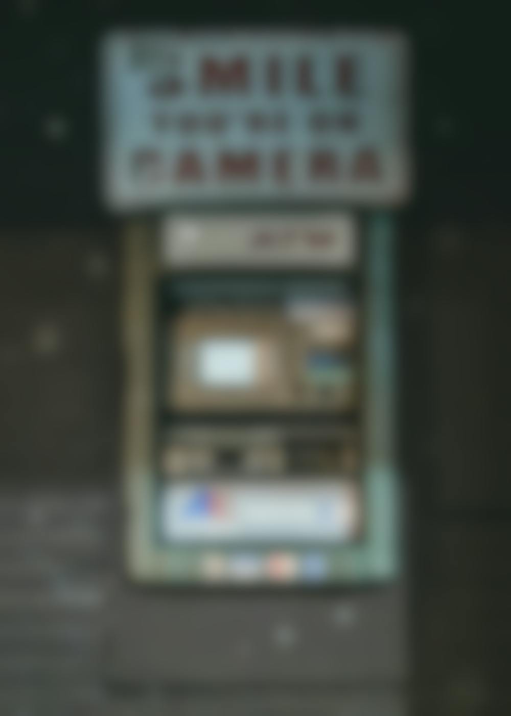An ATM with a sign over it reading, "Smile You're On Camera"