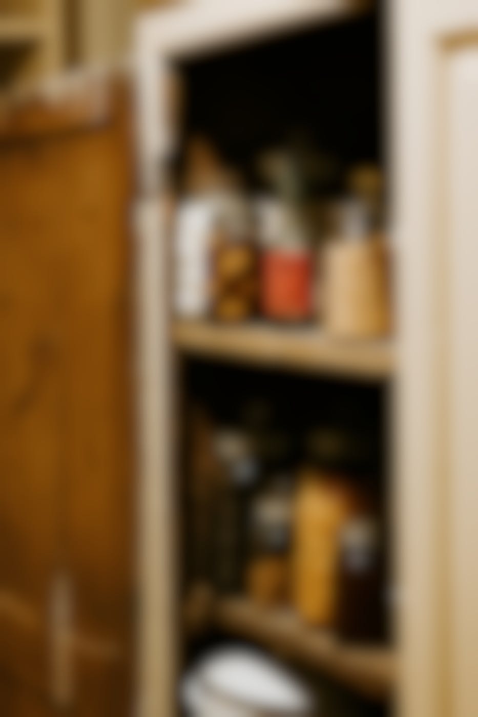 Various jarred and bottled items in a rustic pantry