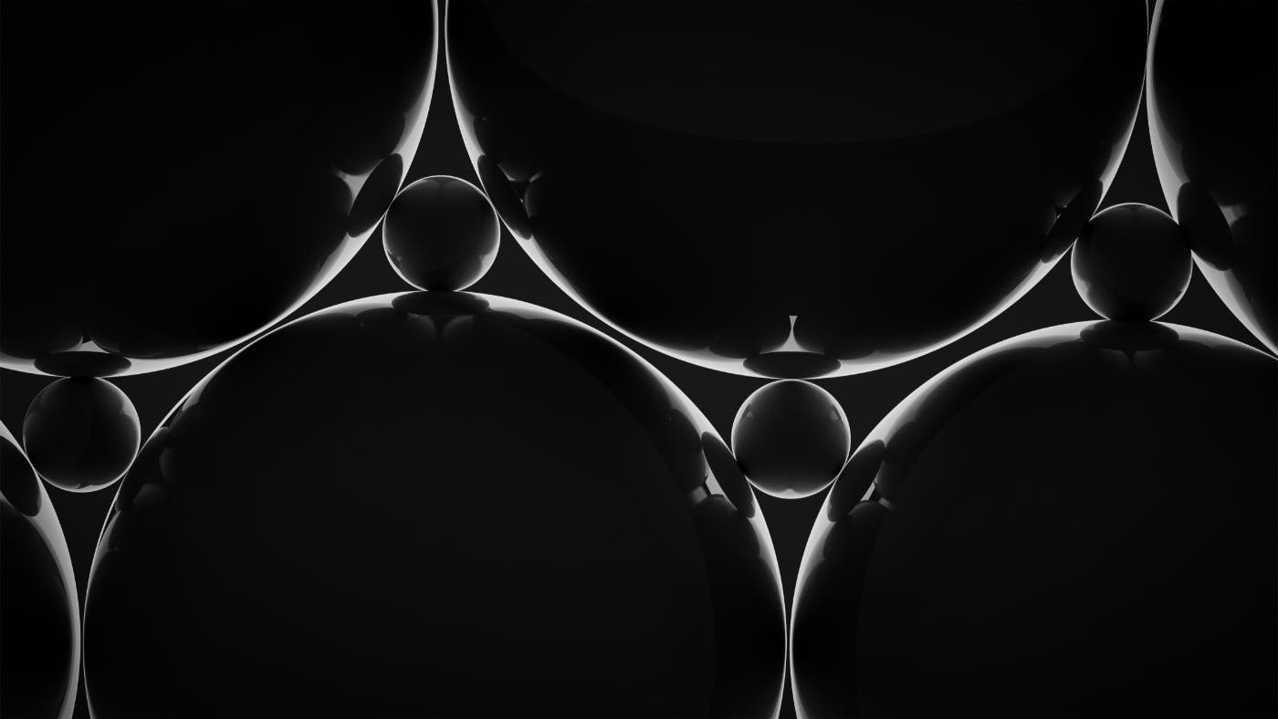 An arrangement of small and large dark reflective spheres