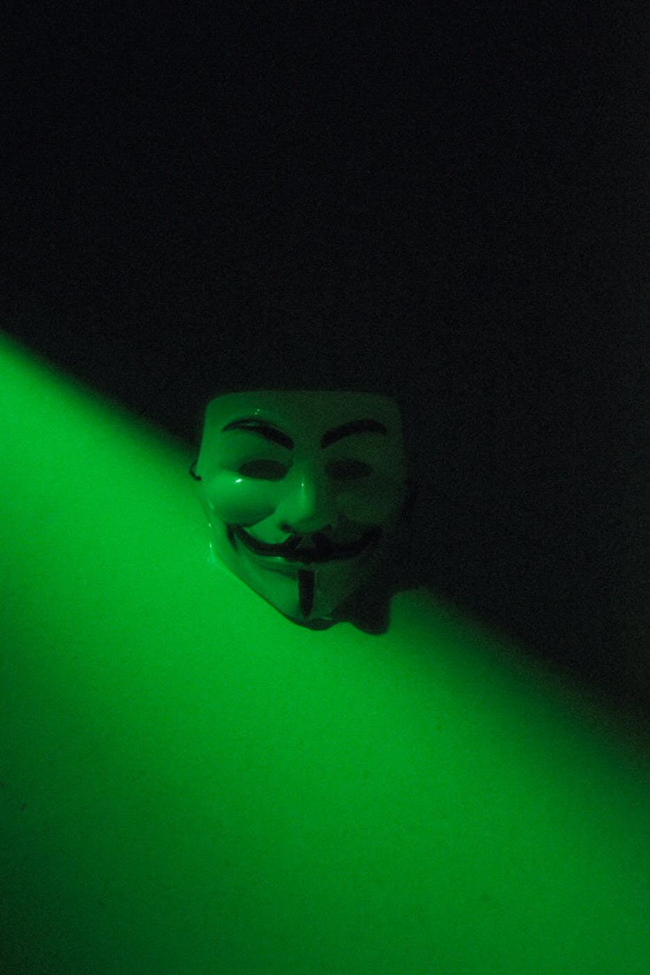 The anonymous mask on a black and green background