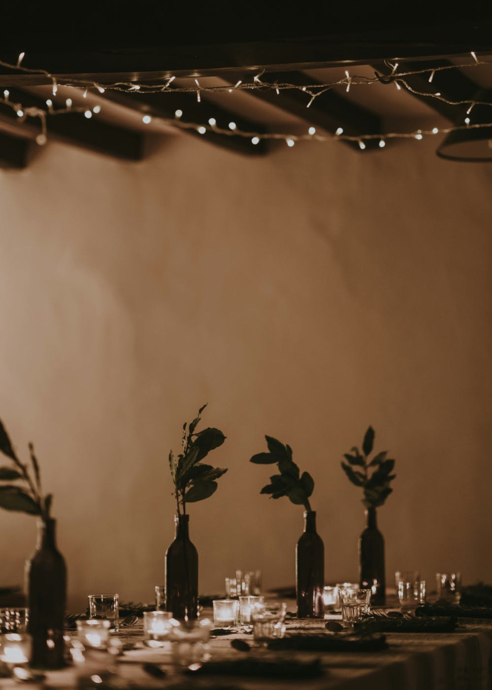 A beautifully set dinning table under low light