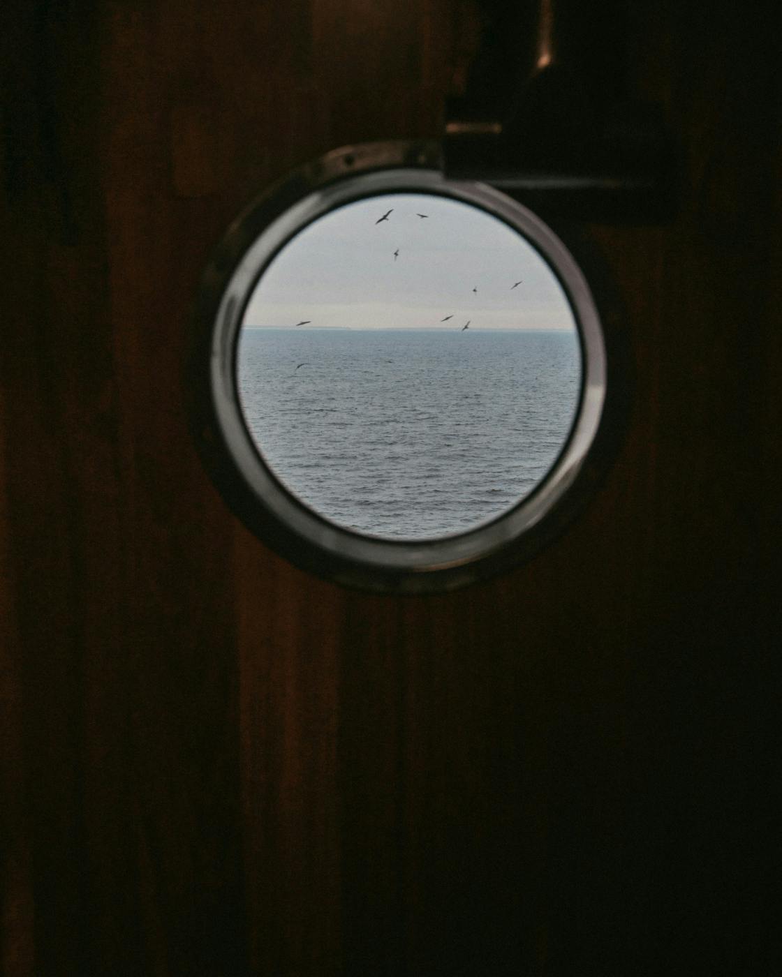 A port hole with a view of the open ocean