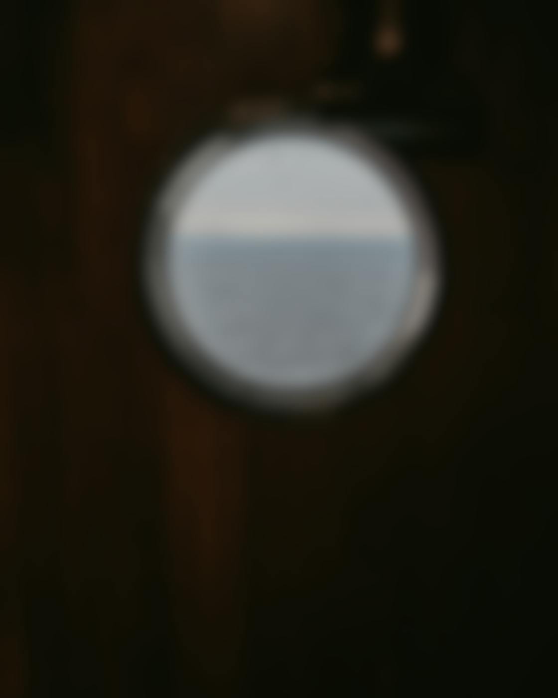 A port hole with a view of the open ocean