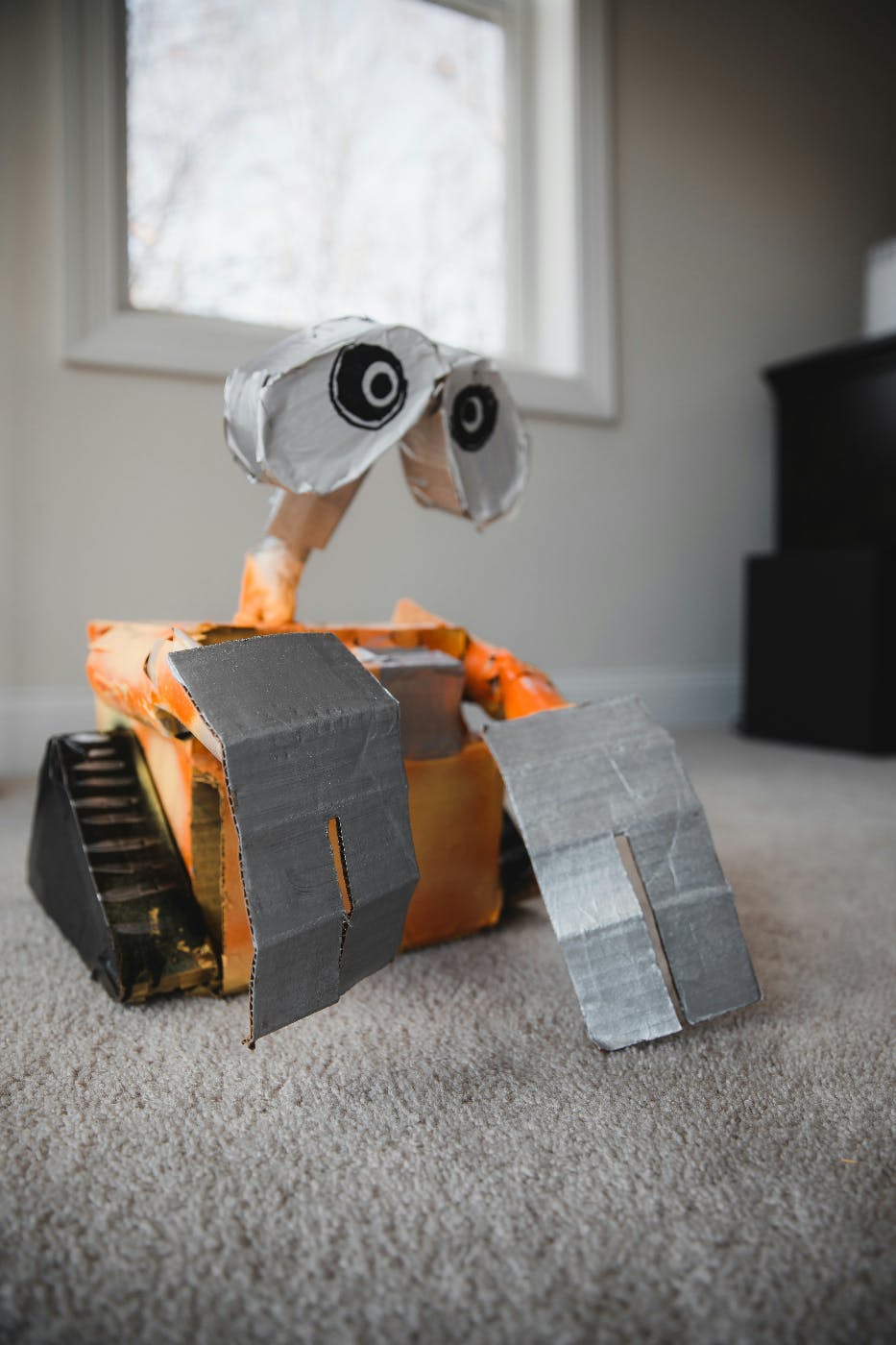 A wall-e robot made of cardboard and duct tape