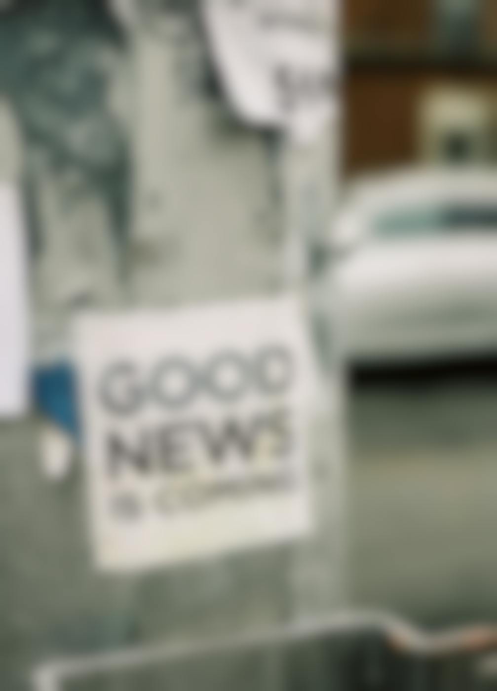 A poster on a phone pole reading Good News Is Coming