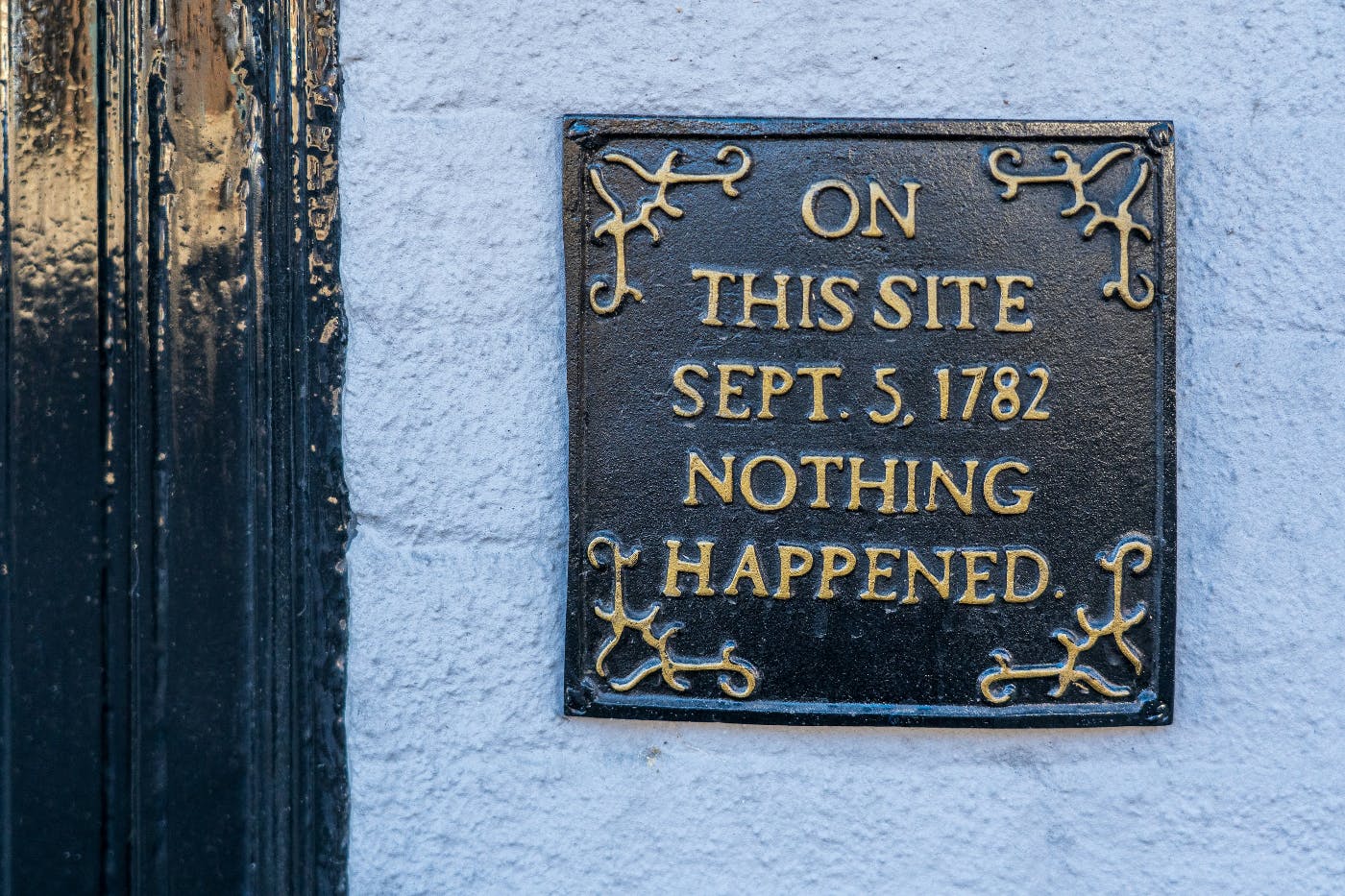 A plaque on a blue wall reading: On This Site Sept. 5, 1782 Nothing Happened