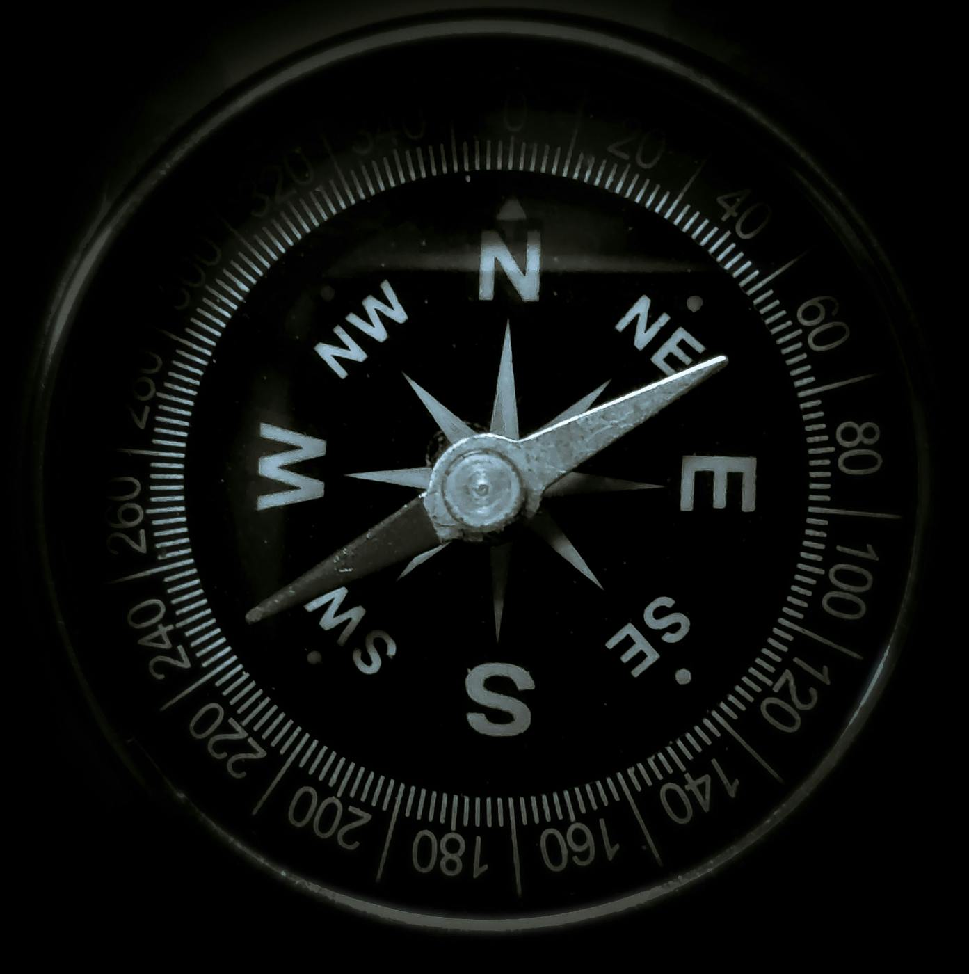 Black & White image of a compass, pointing to NE