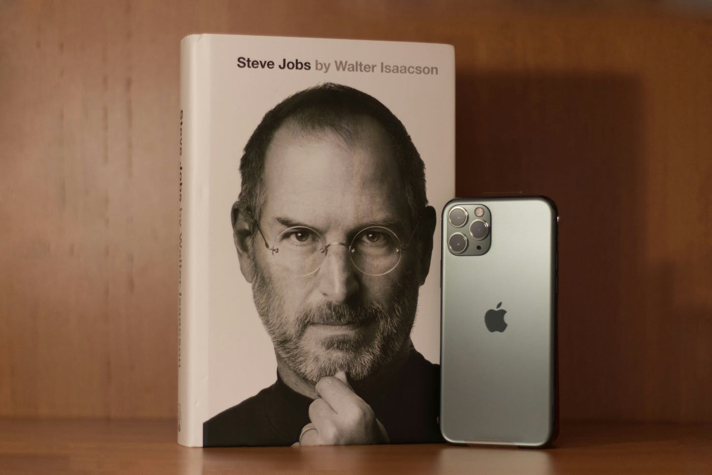 The Biography of Steve Jobs and an iPhone on a shelf