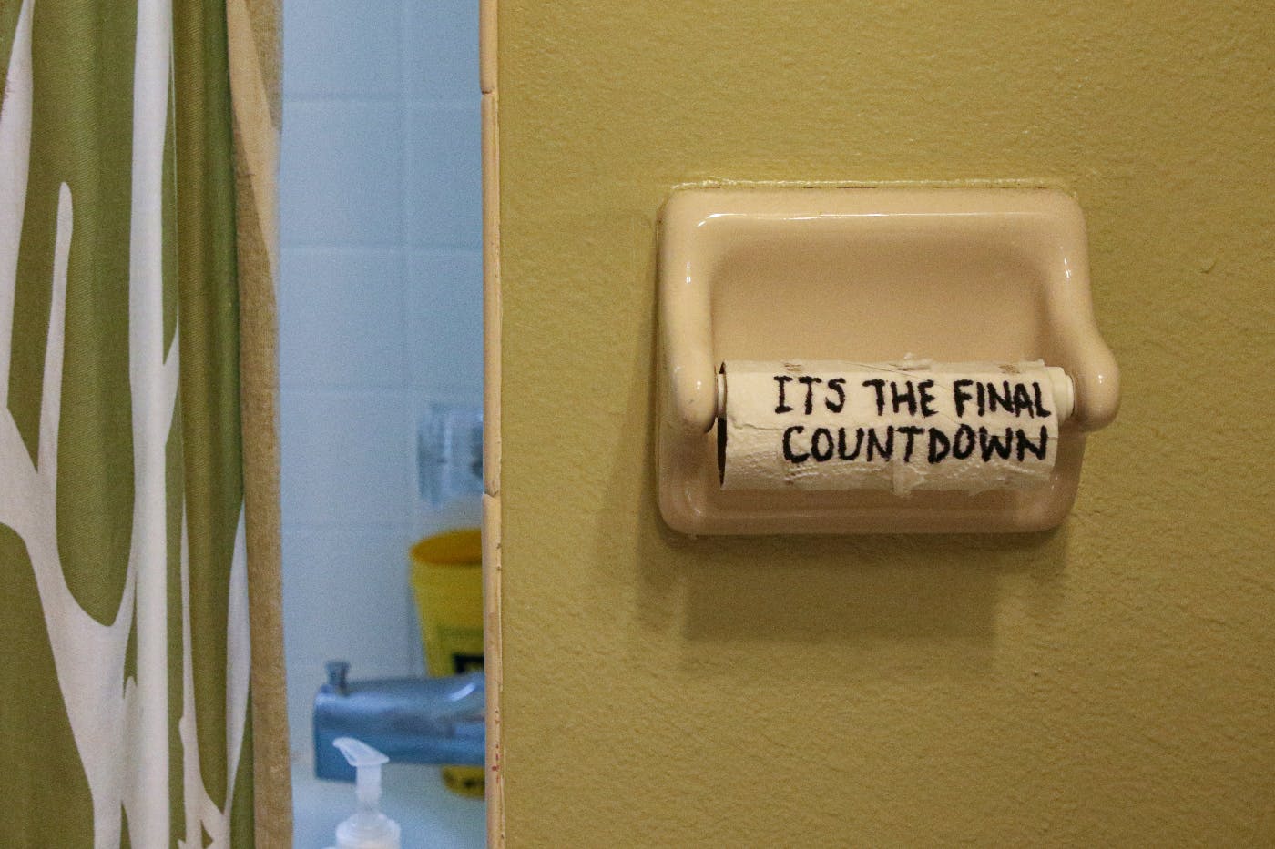 The end of a toilet paper roll that someone has written on: Its the final countdown.