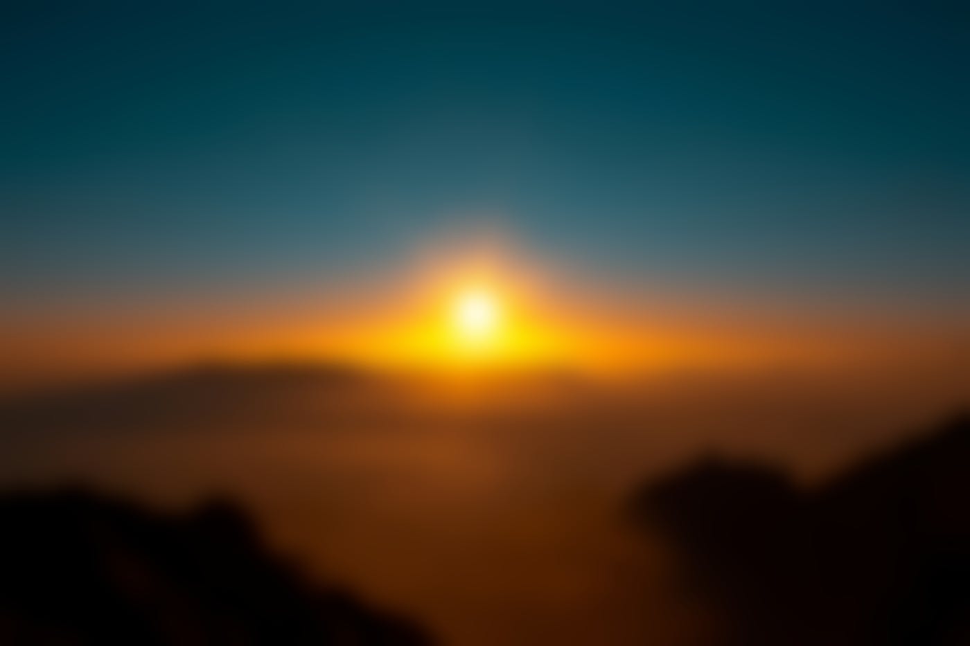 A sunrise over the mountains and the mists