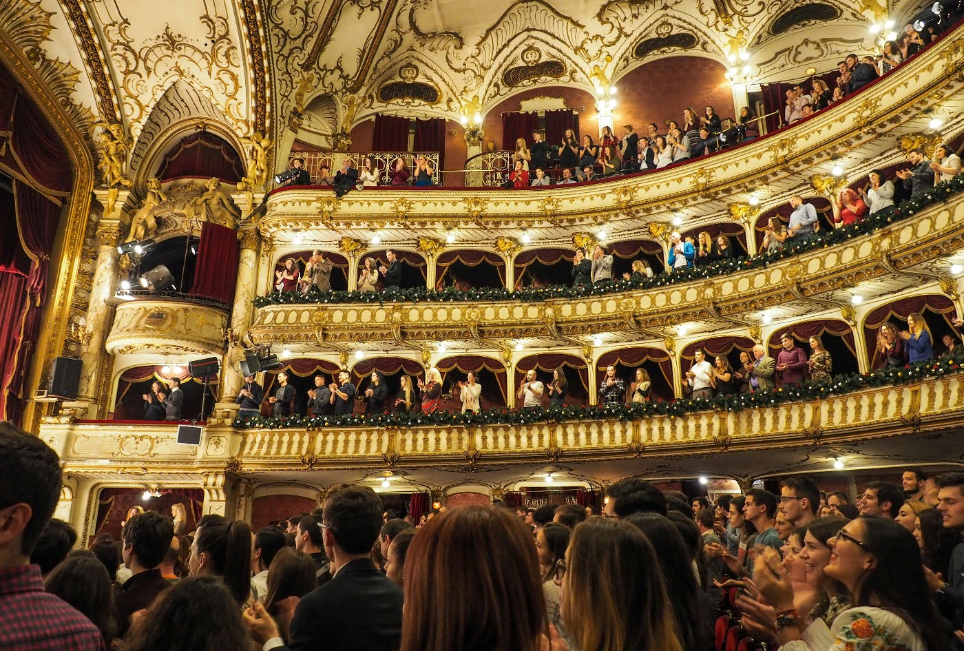 A standing ovation inside an ornate theater