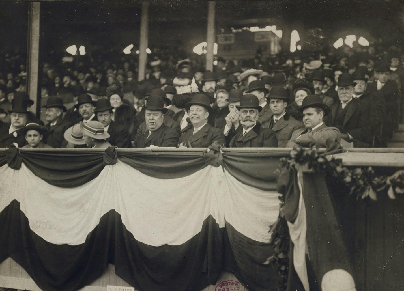 A black and white picture of old men in bowler hats at Fenway Park in Boston