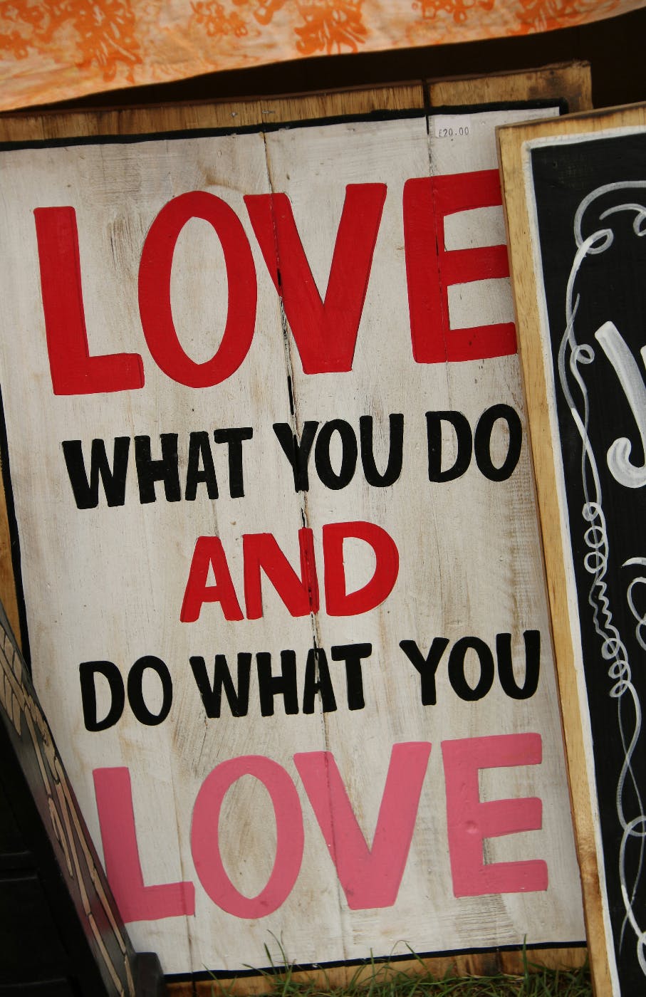 a wood sign with Love what You Do And Do What You Love On it