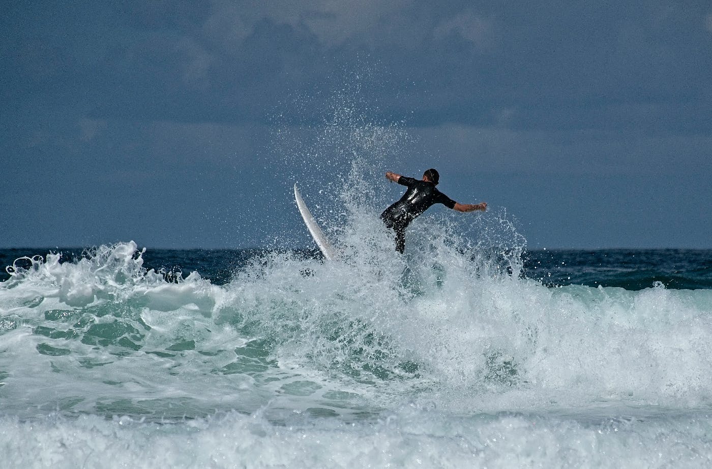 A surfer on top of  a wave