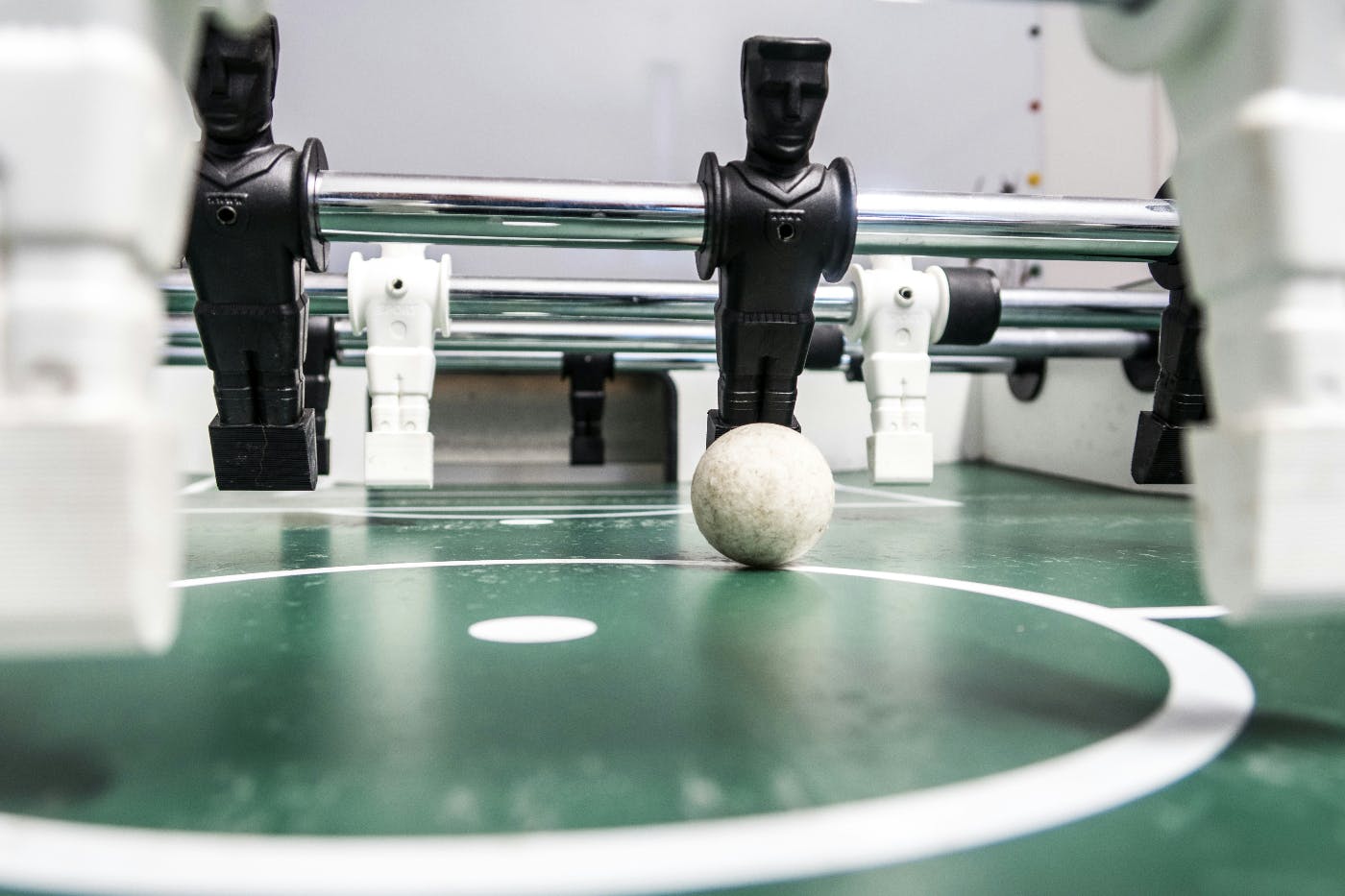 Close up on a foosball table, black and white pieces