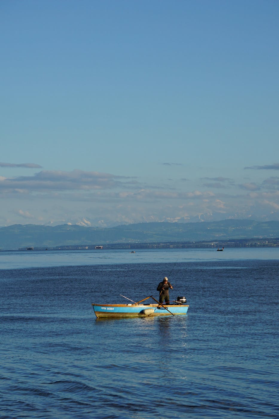 A man in a small boat fishing