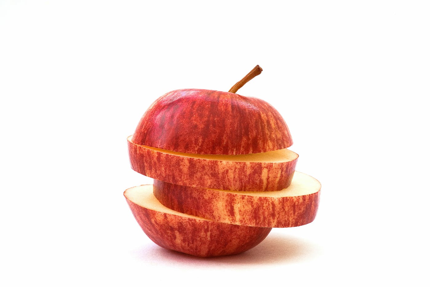 An apple cut in 4 horizontal slices