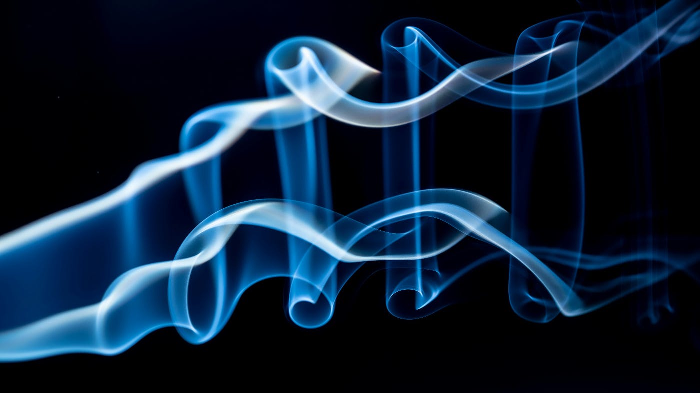 Blue smoke against a black background