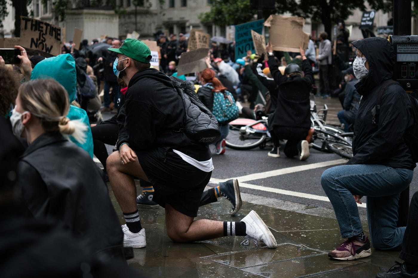 People taking a knee at an outdoor assembly