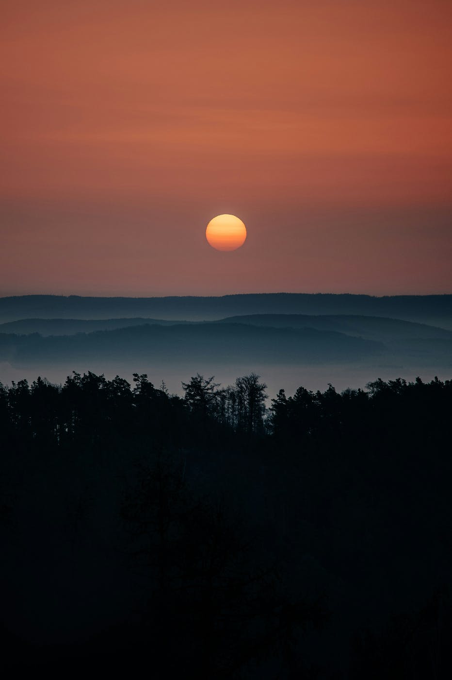 Sun rise over misty mountains and forests